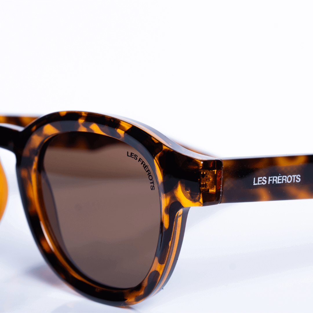 Vintage designed brown oval sunglasses for men, close front angle