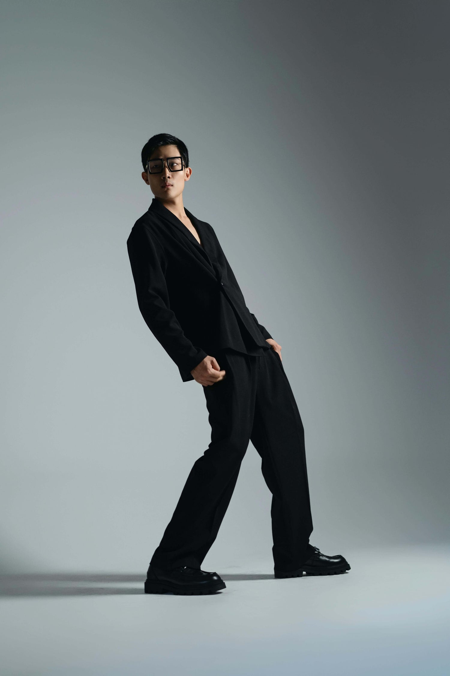 Asian male model standing while wearing transparent lens sunglasses