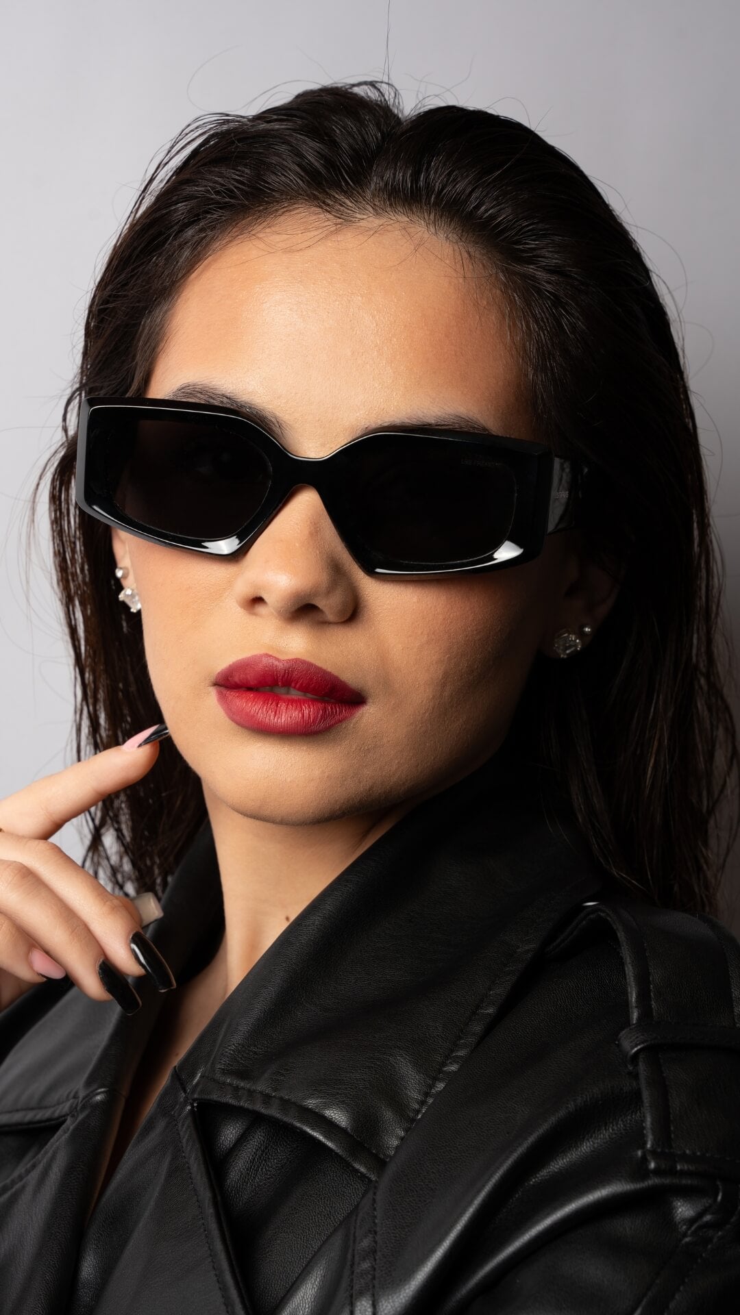 Female model wearing black rectangle sunglasses, front angle 